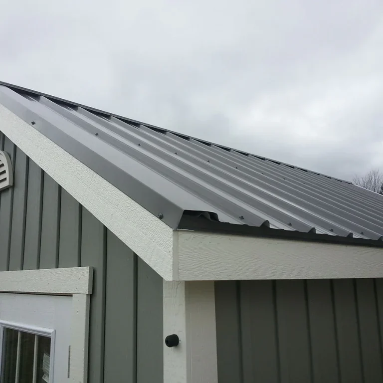 Close up of a durable metal roof on a garage. Close up photo of the corner of a garage with a quality metal roof.